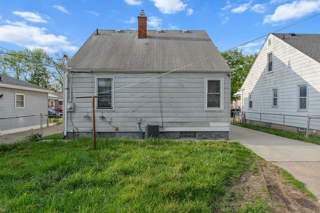 7044 Continental Ave, Warren, MI 48091 - rear view of property featuring a chimney and fence