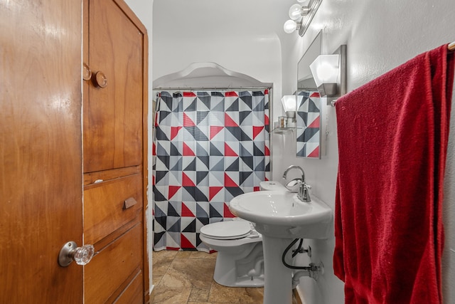 7044 Continental Ave, Warren, MI 48091 - full bath with stone finish floors, toilet, and a shower with shower curtain