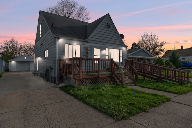 7044 Continental Ave, Warren, MI 48091 - view of front of home featuring an outbuilding, a detached garage, concrete driveway, a deck, and roof with shingles