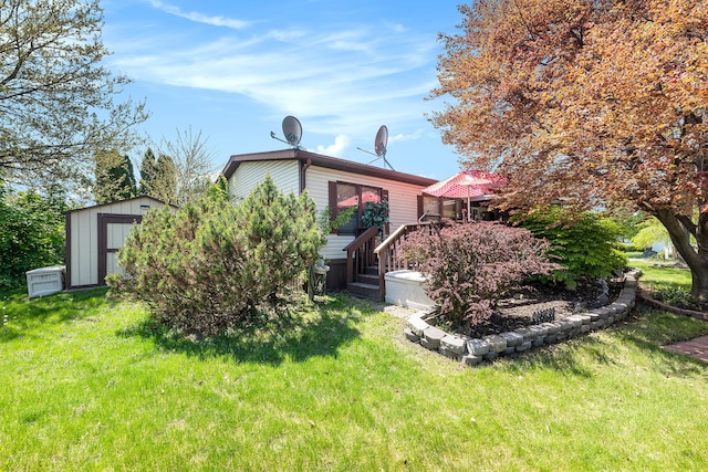 20616 Harmony, Clinton Township, MI 48036 - rear view of house with a storage unit, an outbuilding, and a lawn