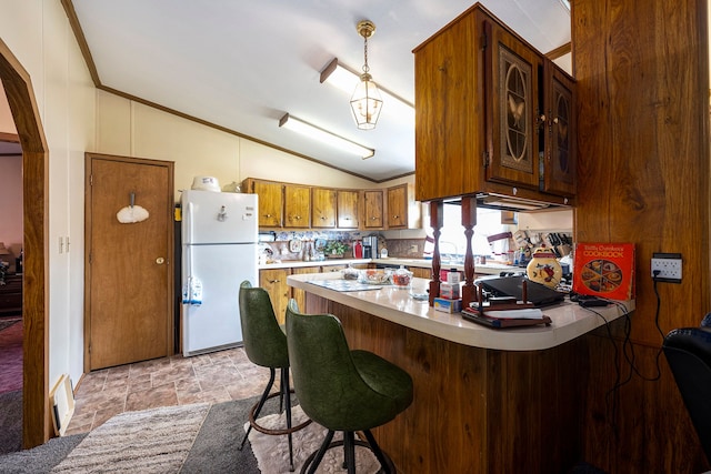 20616 Harmony, Clinton Township, MI 48036 - kitchen featuring freestanding refrigerator, lofted ceiling, a peninsula, light countertops, and stone finish floors