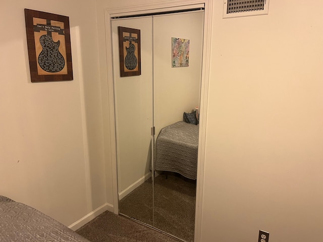 bedroom with carpet, a closet, and baseboards