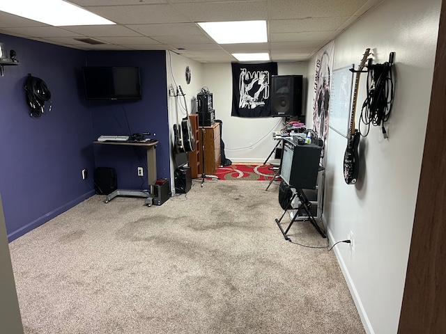game room with carpet, a drop ceiling, and baseboards