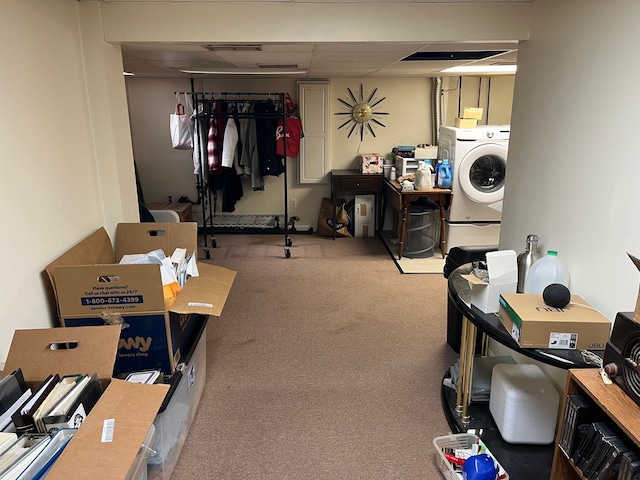finished basement with carpet floors, washer / dryer, and a drop ceiling