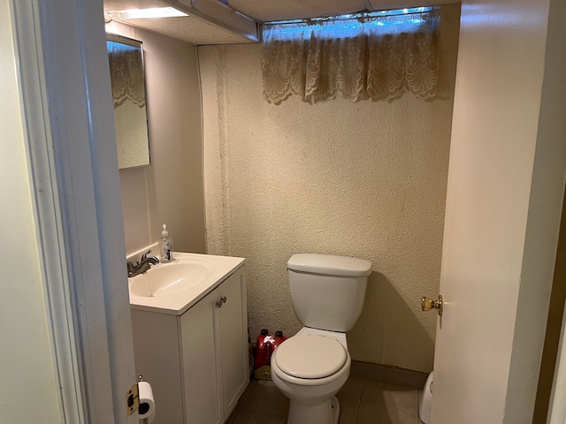 bathroom featuring vanity, tile patterned floors, and toilet