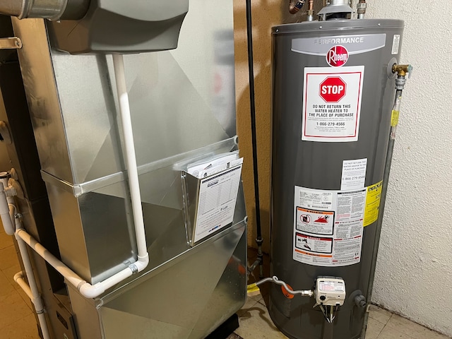 utility room featuring gas water heater and heating unit