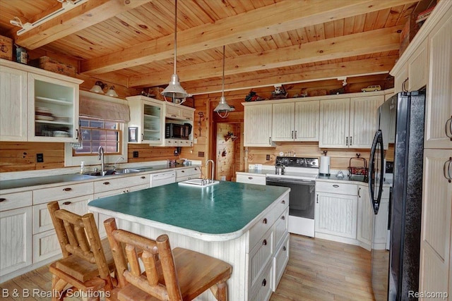 10071 Hillman Rd, Lakeview, MI 48850 - kitchen with white appliances, a sink, light wood-type flooring, wooden ceiling with exposed beams, and hanging light fixtures