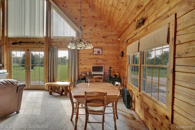 10071 Hillman Rd, Lakeview, MI 48850 - carpeted dining room with lofted ceiling, wooden walls, wooden ceiling, and french doors