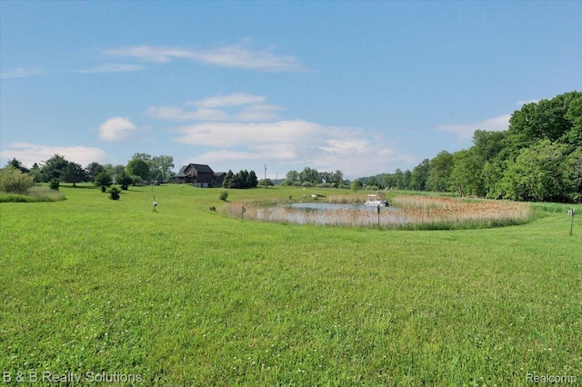 10071 Hillman Rd, Lakeview, MI 48850 - view of green lawn with a water view