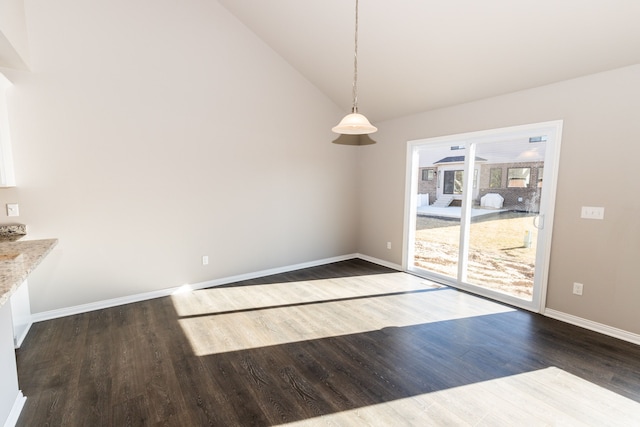49681 Manistee Dr Unit 86, Chesterfield, MI 48047 - unfurnished dining area featuring wood finished floors, baseboards, and vaulted ceiling