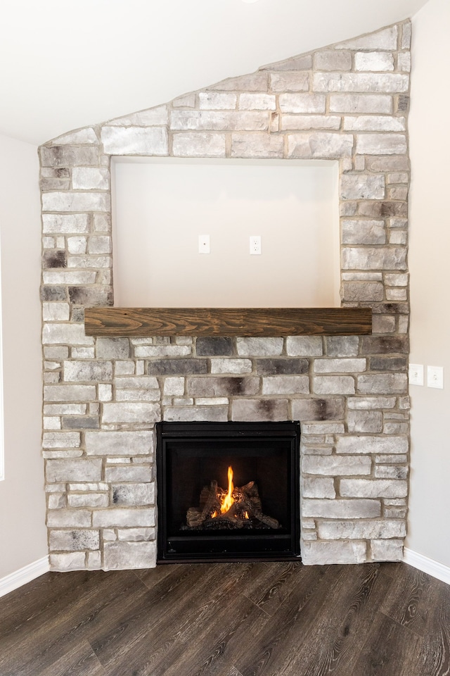 49681 Manistee Dr Unit 86, Chesterfield, MI 48047 - detailed view of a stone fireplace, baseboards, and wood finished floors