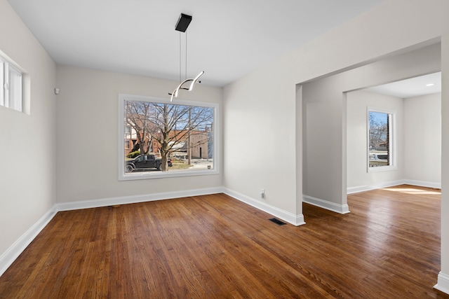 5027 Audubon Rd, Detroit, MI 48224 - unfurnished dining area featuring baseboards and wood finished floors