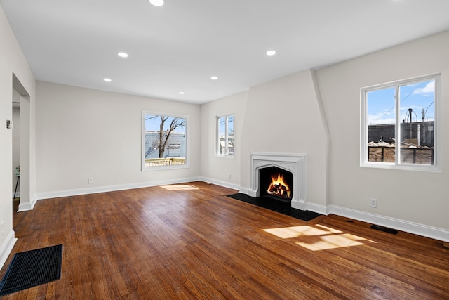 5027 Audubon Rd, Detroit, MI 48224 - unfurnished living room with a fireplace with flush hearth, wood finished floors, baseboards, and recessed lighting