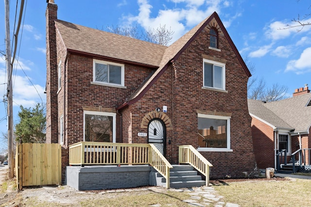 5027 Audubon Rd, Detroit, MI 48224 - english style home with brick siding, a shingled roof, and a chimney