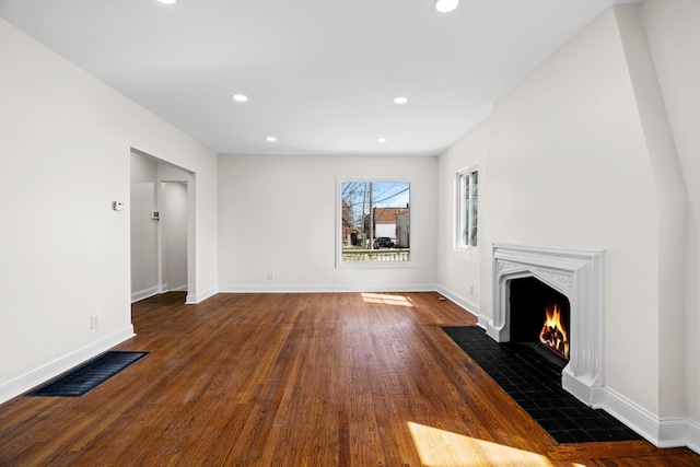 5027 Audubon Rd, Detroit, MI 48224 - unfurnished living room featuring wood finished floors, a fireplace with flush hearth, recessed lighting, and baseboards