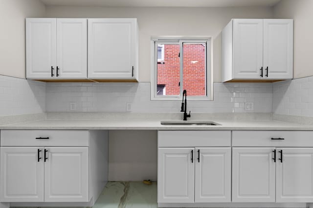 5027 Audubon Rd, Detroit, MI 48224 - kitchen featuring a sink, white cabinets, marble look tile flooring, and light countertops