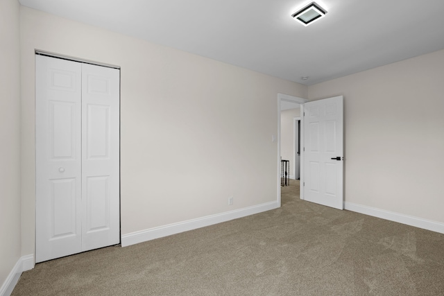 5027 Audubon Rd, Detroit, MI 48224 - unfurnished bedroom featuring carpet, baseboards, and a closet