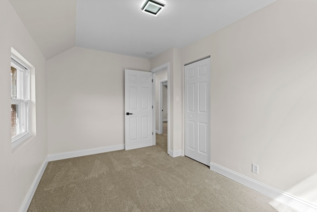 5027 Audubon Rd, Detroit, MI 48224 - unfurnished bedroom with carpet flooring, baseboards, a closet, and lofted ceiling