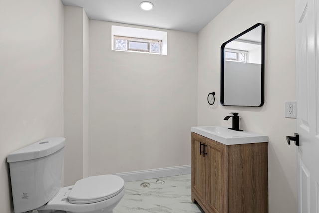 5027 Audubon Rd, Detroit, MI 48224 - half bath featuring marble look tile flooring, toilet, vanity, and baseboards