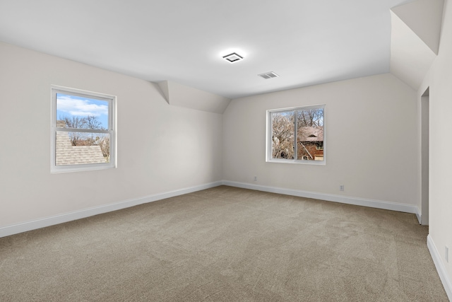 5027 Audubon Rd, Detroit, MI 48224 - carpeted empty room featuring vaulted ceiling and baseboards