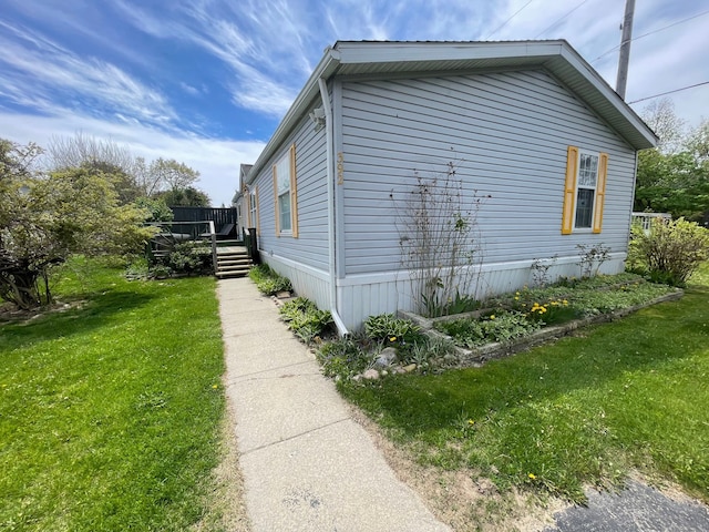 392 Hunters Rill, Oxford, MI 48371 - view of side of home featuring a lawn and a deck