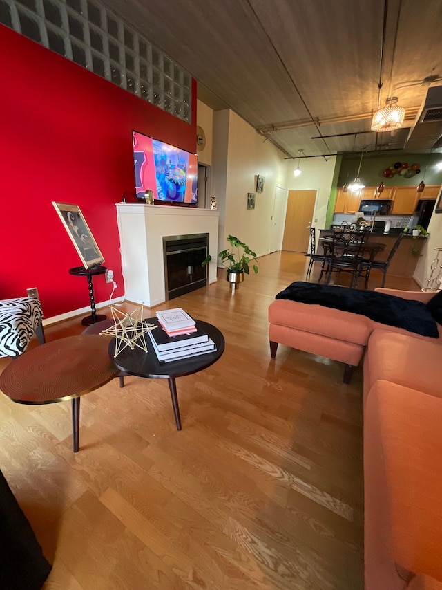 66 Winder St Unit 325, Detroit, MI 48201 - living room with wood finished floors and a fireplace