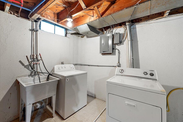 30657 Moulin Ave, Warren, MI 48088 - laundry area with washing machine and clothes dryer, electric panel, and light flooring