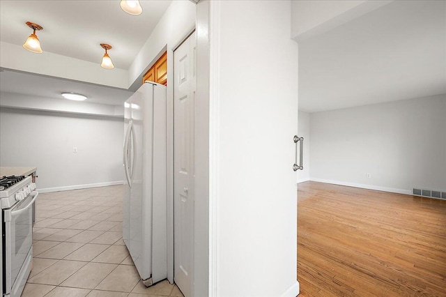 30657 Moulin Ave, Warren, MI 48088 - kitchen with white appliances, baseboards, and light tile patterned floors