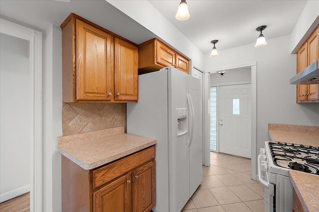 30657 Moulin Ave, Warren, MI 48088 - kitchen featuring white appliances, backsplash, light countertops, and brown cabinetry