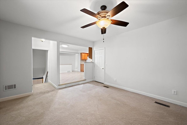 30657 Moulin Ave, Warren, MI 48088 - spare room featuring light carpet, a ceiling fan, and baseboards