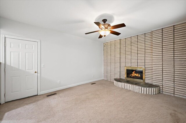 30657 Moulin Ave, Warren, MI 48088 - unfurnished living room with carpet floors, a ceiling fan, a brick fireplace, and baseboards