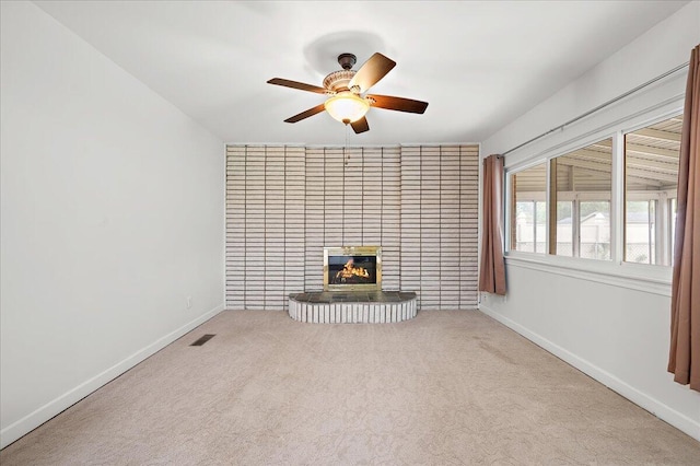 30657 Moulin Ave, Warren, MI 48088 - unfurnished living room featuring carpet, a ceiling fan, a tiled fireplace, and baseboards