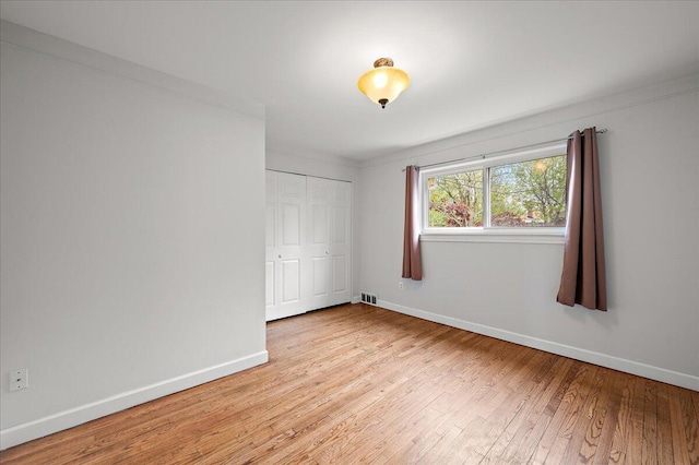 30657 Moulin Ave, Warren, MI 48088 - unfurnished bedroom featuring light wood finished floors, baseboards, and a closet