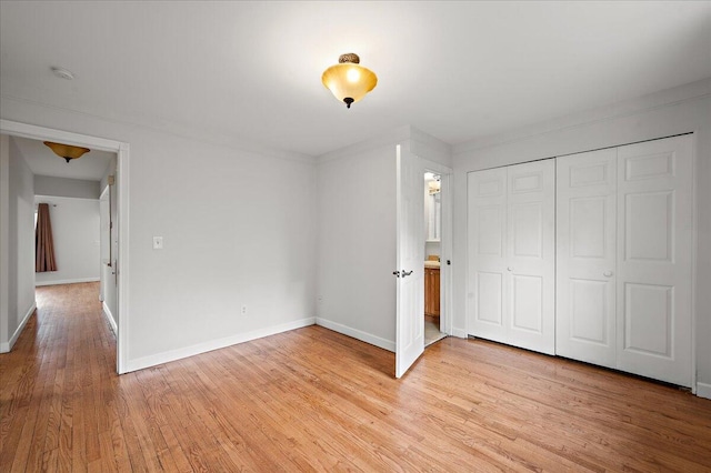 30657 Moulin Ave, Warren, MI 48088 - unfurnished bedroom with light wood finished floors, baseboards, and a closet