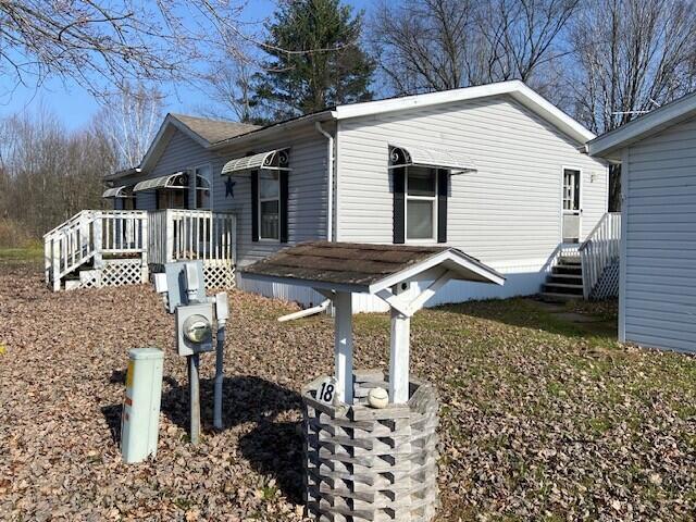 view of property exterior with a wooden deck