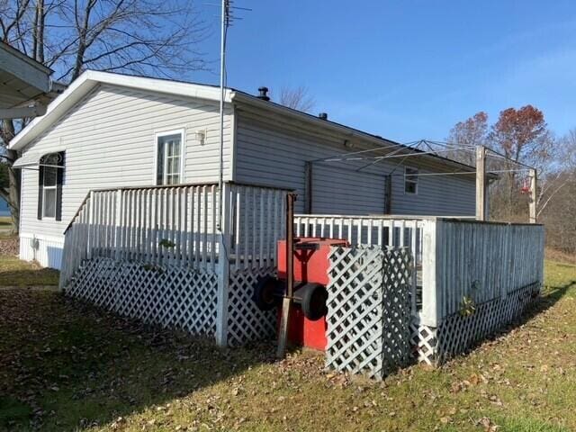 rear view of property with a wooden deck