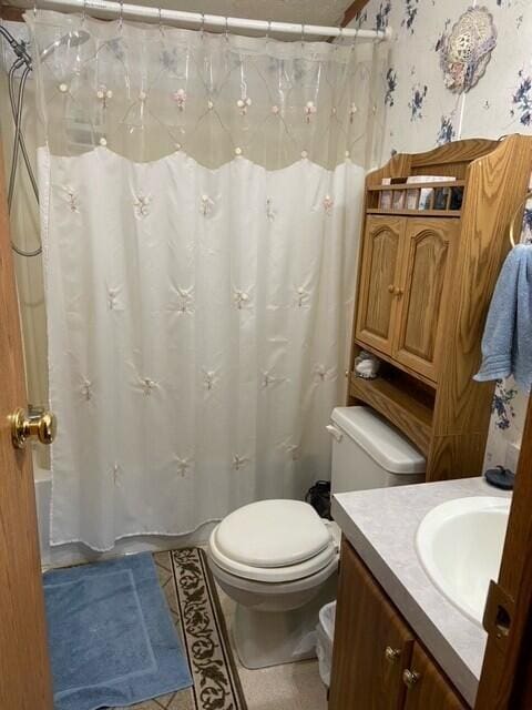 full bath with toilet, tile patterned floors, vanity, and shower / bathtub combination with curtain
