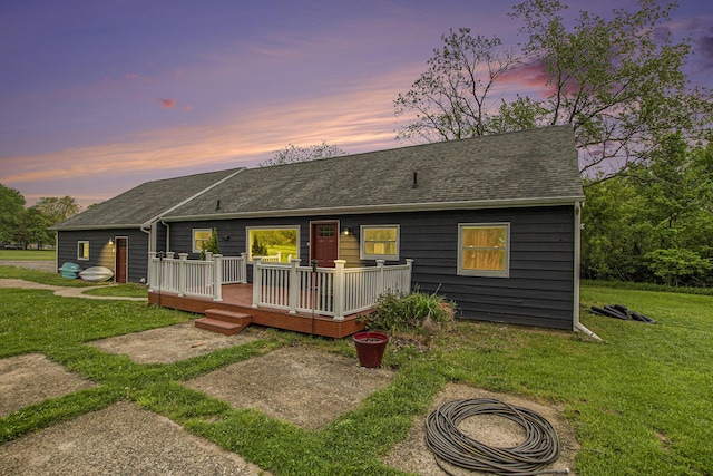 557 W James St, Lawrence, MI 49064 - view of front of house featuring roof with shingles, a deck, and a front lawn