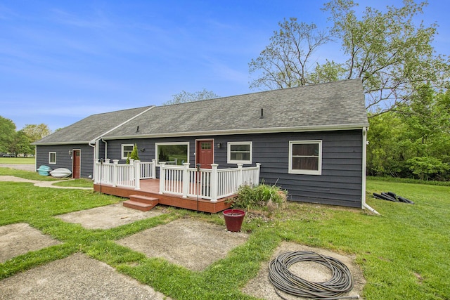 557 W James St, Lawrence, MI 49064 - view of front facade with a deck, a shingled roof, and a front yard