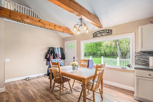 557 W James St, Lawrence, MI 49064 - dining room featuring baseboards, a chandelier, and light wood-style flooring