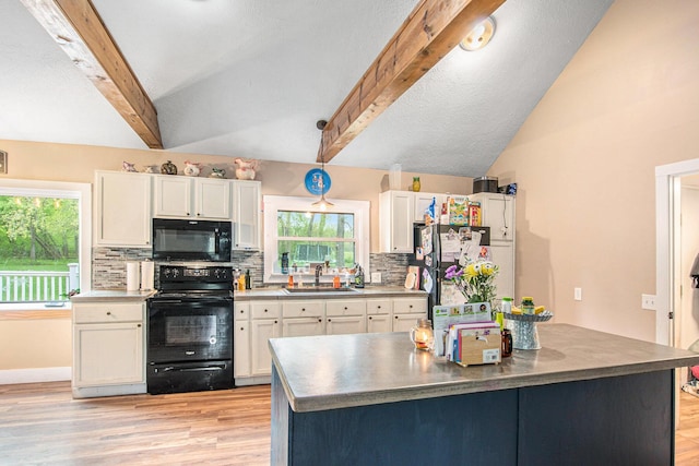 557 W James St, Lawrence, MI 49064 - kitchen with black appliances, a sink, white cabinets, decorative backsplash, and healthy amount of natural light