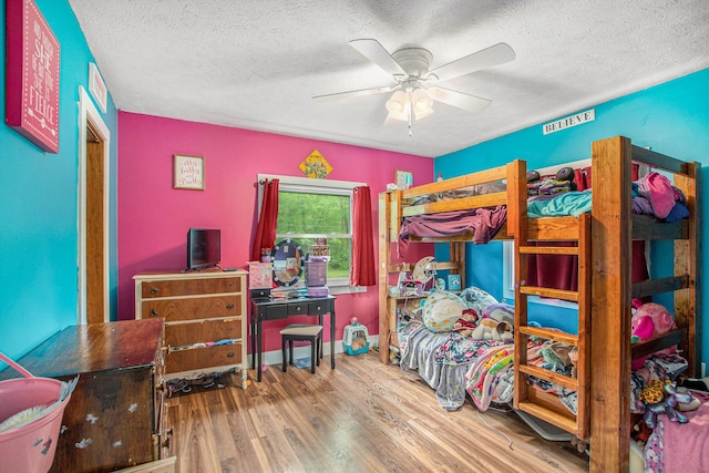 557 W James St, Lawrence, MI 49064 - bedroom with wood finished floors, a textured ceiling, and a ceiling fan