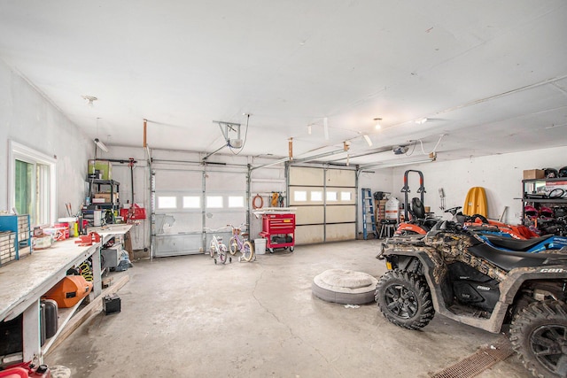 557 W James St, Lawrence, MI 49064 - garage with a workshop area and a garage door opener
