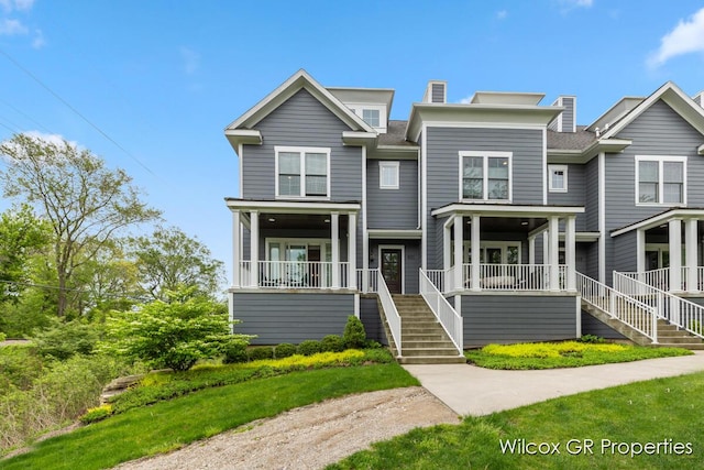 631 Greenslate Dr SE, Ada, MI 49301 - multi unit property with stairs, covered porch, and a chimney