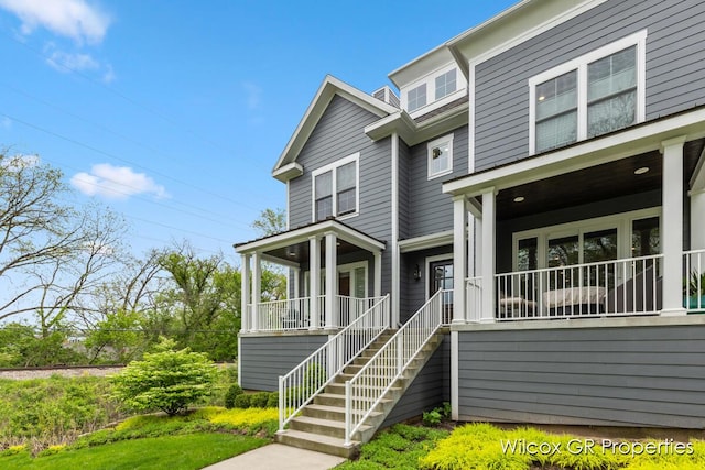 631 Greenslate Dr SE, Ada, MI 49301 - view of front of home with a porch and stairway