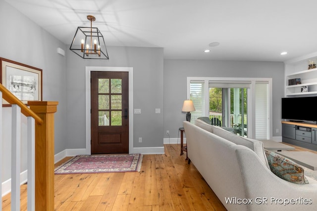 631 Greenslate Dr SE, Ada, MI 49301 - foyer featuring light wood finished floors, a chandelier, recessed lighting, and baseboards