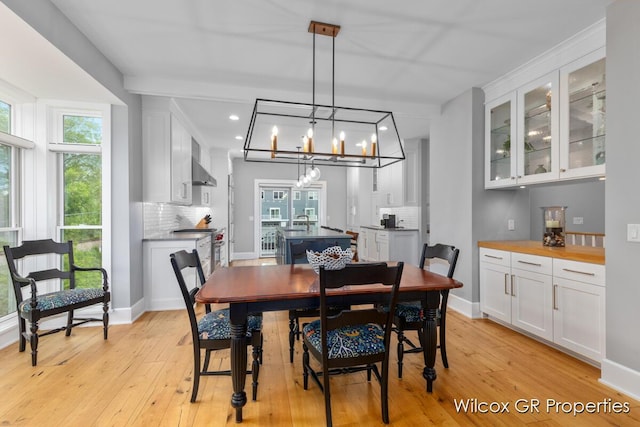 631 Greenslate Dr SE, Ada, MI 49301 - dining room with light wood-style floors, recessed lighting, and a chandelier