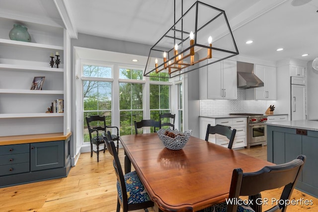 631 Greenslate Dr SE, Ada, MI 49301 - dining room with light wood-type flooring, recessed lighting, and a chandelier