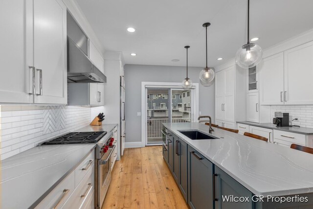 631 Greenslate Dr SE, Ada, MI 49301 - kitchen featuring high end stainless steel range oven, a sink, white cabinetry, recessed lighting, and decorative backsplash