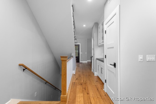 631 Greenslate Dr SE, Ada, MI 49301 - hall with an upstairs landing, recessed lighting, light wood-style flooring, and baseboards